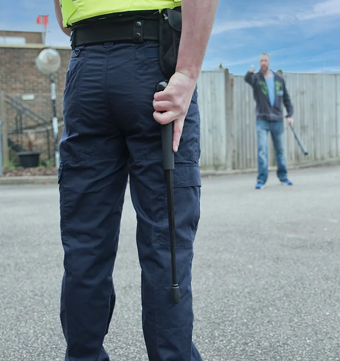 Batons behind a police officers back